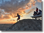 Son running down a sand dune at Jones Beach, Wantagh, Long Island -  Photo by Stephen Faulkner