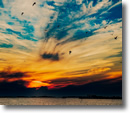 A vibrant, cloud-filled sunrise over Zach's Bay - Photo by Patty Mueller